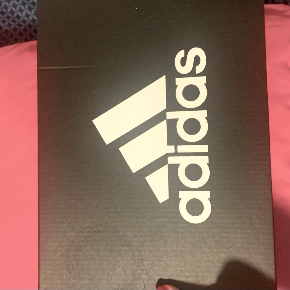 Adidas Shoes. black and white with a light cream color on the bottom of the shoe